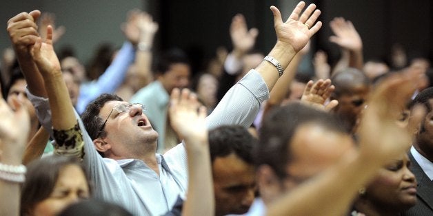 TO GO WITH AFP STORY
People attend a mass of the Assembly of God church, in Goiania, Goias State, Brazil, on May 19, 2013. T
