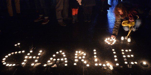 People light candles forming the name Charlie during a gathering in Strasbourg, eastern France, on January 7, 2015, following an attack by unknown gunmen on the offices of the satirical weekly Charlie Hebdo. Heavily armed men shouting 'Allahu Akbar' stormed the Paris headquarters of a satirical weekly on January 7, killing 12 people in cold blood in the worst attack in France in decades. AFP PHOTO / PATRICK HERTZOG (Photo credit should read PATRICK HERTZOG/AFP/Getty Images)