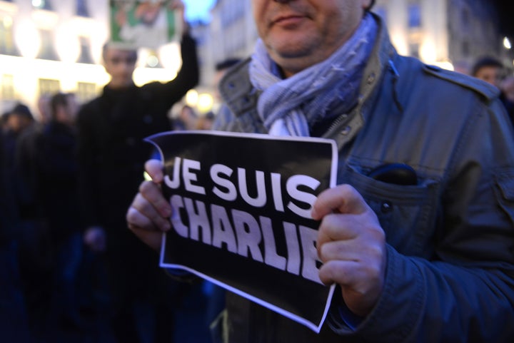 People take part in a vigil in Nantes, western France, Wednesday January 7, 2015, after three gunmen carried out a deadly ter