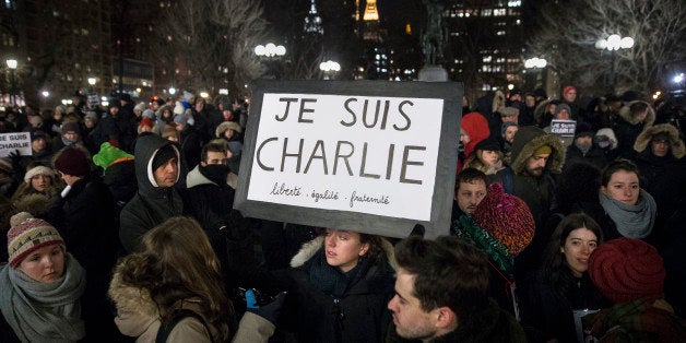 Mourners attend a rally in support of Charlie Hebdo, a French satirical weekly newspaper that fell victim to an terrorist attack, Wednesday, Jan. 7, 2015, at Union Square in New York. French officials say 12 people were killed when masked gunmen stormed the Paris offices of the periodical that had caricatured the Prophet Muhammad. (AP Photo/John Minchillo)