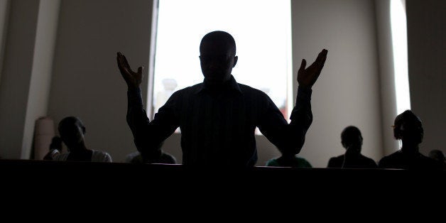 PORT-AU-PRINCE, HAITI - JANUARY 11: People pray in the new church built next to the National Cathedral that was destroyed fi