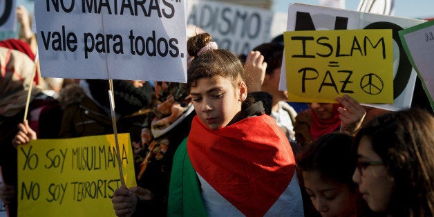 MADRID, SPAIN - JANUARY 11: Muslim protesters hold placards reading 'I am Muslim, Not a terrorist, Not on my name' (bottom), 'You won't kill. That works for everyone' (Top, L) and 'Islam equal Peace' (R) during a demonstration outside Atocha Station against the recent Paris terrorist attacks on January 11, 2015 in Madrid, Spain. Arabs Culture Foundation (FUNCA) called for a demonstration with the support of more than fifty mosques under the slogan 'Against terrorism and radicalisms' in reaction to several terrorist attacks that started inside Charlie Hebdo magazine's office, and had taken the lives of seventeen people and three suspects in Paris this week. (Photo by Pablo Blazquez Dominguez/Getty Images)