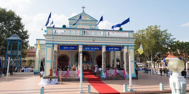 Pope Francis delivers a prayer at the church of Our Lady of Madhu in Madhu, Sri Lanka,Wednesday, Jan. 14, 2015. Thousands of people waving the white and yellow Vatican flags were on hand to welcome Francis to the Our Lady of Madhu shrine, which is revered by both Sinhalese and Tamil Catholics, as well as Sri Lankans of other faiths. Francis also traveled to the jungles of war-torn northern Sri Lanka on Wednesday to show solidarity with the victims of the country's 25-year civil war and urge forgiveness and reconciliation "for all the evil which this land has known." (AP Photo/L'Osservatore Romano, Pool)