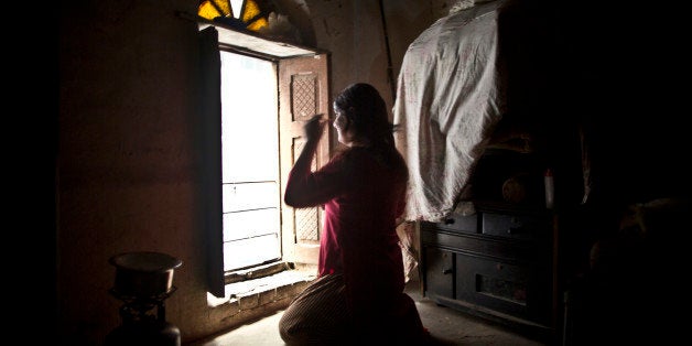 In this Thursday, Jan. 8, 2015 photo, Pakistani Bakhtawar Ijaz, 43, sits in front of the window combing his wig, while preparing himself to go out, at his place in Rawalpindi, Pakistan. Across conservative Pakistan, where Islamic extremists launch near-daily attacks and many follow a strict interpretation of their Muslim faith, those like Bakhtawar face a challenge of balancing two identities. Some left their villages for the anonymity of a big city, fearing the reactions of their families while still concealing identity from neighbors and co-workers. (AP Photo/Muhammed Muheisen)