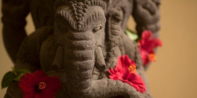 JAKARTA, INDONESIA - NOVEMBER 02: Statue of the Hindu divinity Ganesha, also known as Ganapati and Vinayaka, with hibiscus flower on November 02, 2014, in Jakarta, Indonesia. Ganesha is one of the best-known and most worshipped deities in the Hindu pantheon. Photo by Ute Grabowsky/Photothek via Getty Images)***Local Caption***