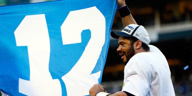 SEATTLE, WA - JANUARY 18: Russell Wilson #3 of the Seattle Seahawks waves the 12th Man flag after the Seahawks defeated the Green Bay Packers in the 2015 NFC Championship game at CenturyLink Field on January 18, 2015 in Seattle, Washington. (Photo by Kevin C. Cox/Getty Images)