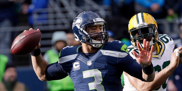 Seattle Seahawks quarterback Russell Wilson drops back to pass during the first half of the NFL football NFC Championship game against the Green Bay Packers Sunday, Jan. 18, 2015, in Seattle. (AP Photo/David J. Phillip)