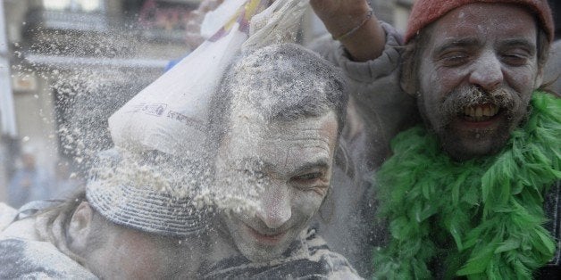 People enjoy the 'Domingo Fareleiro' (floury Sunday in Galician language) carnival festival in the village of Xinzo de Limia, northwestern Spain, on January 25, 2015. During this festive battle participants throw flour against each other as a kind of purification ritual. AFP PHOTO/MIGUEL RIOPA (Photo credit should read MIGUEL RIOPA/AFP/Getty Images)