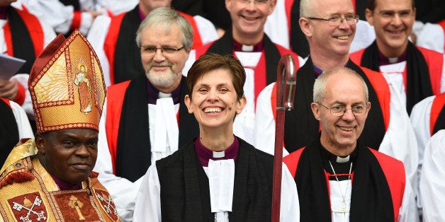 YORK, ENGLAND - JANUARY 26: The Reverend Libby Lane smiles as she stands next to the Archbishop of Canterbury, Justin Welby, (R) and the Archbishop of York, Dr John Sentamu outside York Minster after she was consecrated as the eighth Bishop of Stockport on January 26, 2015 in York, England. The Church of England consecrated its first female bishop during a ceremony at York Minster today. The Reverend Libby Lane, who has been the vicar of St Peter's Hale and St Elizabeth's Ashley, in Greater Manchester, was ordained as the new Bishop of Stockport in a two hour service led by the Archbishop of York, Dr John Sentamu. (Photo by Jeff J Mitchell/Getty Images)