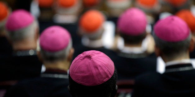 FILE - In this Monday, Oct. 13, 2014 file photo, bishops and Cardinals attend a morning session of a two-week synod on family issues at the Vatican. Catholic bishops scrapped their landmark welcome to gays Saturday, Oct. 18, 2014 showing deep divisions at the end of a two-week meeting sought by Pope Francis to chart a more merciful approach to ministering to Catholic families. The bishops failed to approve even a watered-down section on ministering to homosexuals that stripped away the welcoming tone of acceptance contained in a draft document earlier in the week. (AP Photo/Gregorio Borgia, Files)