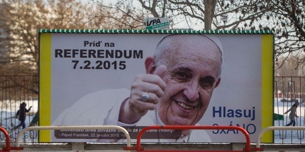 TO GO WITH AFP STORY BY TATIANA BEDNARIKOVA A bilboard with the portrait of the Pope Francis with text encouraging people to vote at a referendum to maintain a ban on same-sex marriage is pictured in Bratislava on February 3, 2015. Slovakia will hold a referendum on February 7, 2015 on whether to maintain a ban on same-sex marriage in the largely Roman Catholic EU member, a move championed by both conservative circles and surprisingly, the leftist government. AFP PHOTO / VLADIMIR SIMICEK (Photo credit should read Vladimir Simicek/AFP/Getty Images)