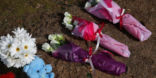 RALEIGH, NC - FEBRUARY 12: Three sets of flowers commemorate three students recently murdered in Chapel Hill, N.C., before