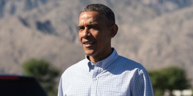 US President Barack Obama walks to greet wellwishers on February 14, 2015 as he arrives in Palm Springs, California where he
