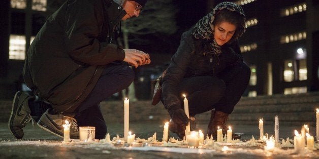 CHAPEL HILL, USA - FEBRUARY 11: Lee Elliott (L) from Chapel Hill, N.C. and Tera Schmitt (R) from Durham, N.C. relight candles