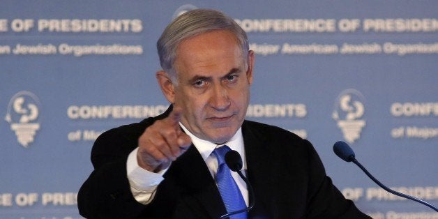 Israeli Prime Minister Benjamin Netanyahu gestures as he delivers a speech during the Presidents Conference of Major American Jewish organizations in Jerusalem on February 16, 2015. Prime Minister Helle Thorning-Schmidt urged Danish Jews not to emigrate despite a call from her Israeli counterpart Benjamin Netanyahu for European Jews to move to Israel following the Copenhagen attacks. AFP PHOTO/GALI TIBBON (Photo credit should read GALI TIBBON/AFP/Getty Images)