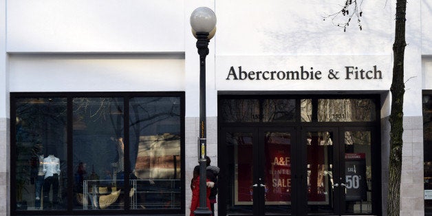 An Abercrombie & Fitch storefront and sign in downtown Seattle, Washington. Pedestrians and lamp posts are on the sidewalk outside the store.