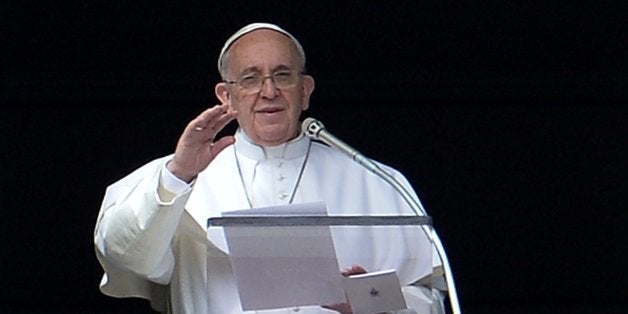 Pope Francis addresses the crowd from the window of the apostolic palace overlooking Saint Peter's square during his Angelus