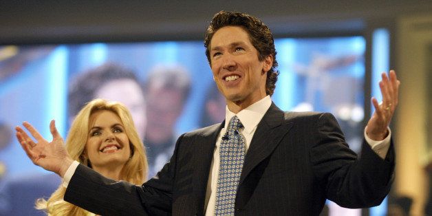 Televangelist and best-selling author, Joel Osteen, right, and his wife, Victoria, left, celebrate the grand opening of the new home for the Lakewood Church, formerly the Compaq Center, Saturday, July 16, 2005, in Houston. The arena that basketball fans once packed to see the NBA's Houston Rockets is taking on a new role, home to the largest congregation in the nation. It took more than 15 months and $75 million to convert the arena into the new home of the largest and fastest growing congregation in the nation.(AP Photo/Jessica Kourkounis)