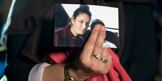 LONDON, ENGLAND - FEBRUARY 22: (EDITORS NOTE: FACE IN PHOTO BEING HELD DELIBERATELY COVERED BY SISTER) Renu Begum, eldest sister of Shamima Begum, 15, holds her sister's photo as she is interviewed by the media at New Scotland Yard, as the relatives of three missing schoolgirls believed to have fled to Syria to join Islamic State have pleaded for them to return home, on February 22, 2015 in London, England. Police are urgently trying to trace Shamima Begum, 15, Kadiza Sultana, 16, and 15-year-old Amira Abase after they flew to Istanbul in Turkey from Gatwick Airport on Tuesday. (Photo by Laura Lean - WPA Pool/Getty Images)