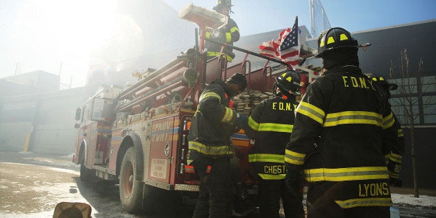 NEW YORK, NY - JANUARY 31: Fire Department of New York (FDNY) firefighters work to contain a building fire that went to six