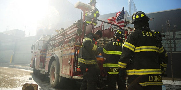 NEW YORK, NY - JANUARY 31: Fire Department of New York (FDNY) firefighters work to contain a building fire that went to six alarms at the CitiStorage warehouse building at 5 North 11th Street near Kent Avenue in the Willamsburg neighborhood of Brooklyn on January 31, 2015 in New York City. The morning fire which started around 6:20 AM has took over 200 firefighters to fight and smoke could be visible for miles. (Photo by Spencer Platt/Getty Images)