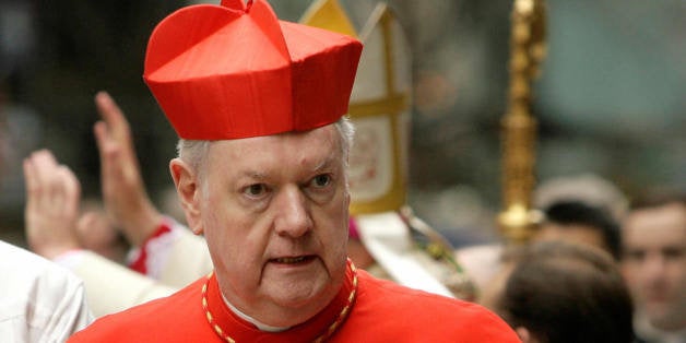 Archbishop Emeritus of New York Edward Egan makes his way into St. Patrick's Cathedral for the celebration of the first Mass