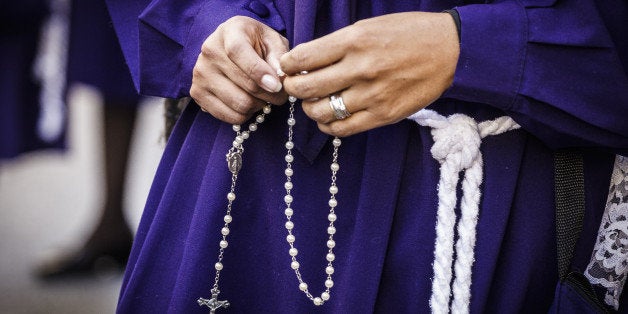 ROME, ITALY - 2014/10/05: Peruvian woman, known as 'Sahumadoras', holds a rosary while participating in a procession in Rome honoring, Peru's most revered Catholic religious icon, the 'Lord of Miracles' or 'SeÃ±or de los Milagros'. The Peruvian community in Italy gather to honor Peru's most revered Catholic religious icon, the Lord of Miracles or SeÃ±or de los Milagros as it is known in Spanish. This is the largest religious procession in America, where worshipers carry the painted image of a black Christ, which survived intact on a church wall, despite an earthquake in 1746 which leveled all surrounding buildings. (Photo by Giuseppe Ciccia/Pacific Press/LightRocket via Getty Images)