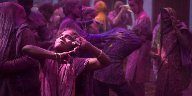 Indian Hindu widows and others play with colored powder as part of Holi celebrations at the Meera Sahabhagini Widow Ashram in Vrindavan, India, Tuesday, March 3, 2015. The widows, many of whom at times have lived desperate lives in the streets of the temple town, celebrated the Hindu festival of colors at the ashram. (AP Photo/Tsering Topgyal)