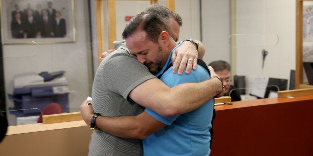 MIAMI, FL - JANUARY 05: Jeff Ronci (L) and Juan Talavera are embrace as they arrive at the Clerk of the Courts - Miami-Dade County Court to obtain their marriage license after the courts announced it was legal on January 5, 2015 in Miami, Florida. Gay marriage is now legal statewide after the courts ruled that the ban on gay marriage is unconstitutional and the Supreme Court declined to intervene. (Photo by Joe Raedle/Getty Images)