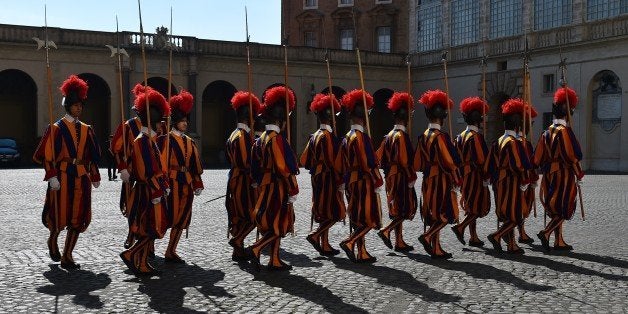 Swiss guards stand in the courtyard of the Vatican on March 9, 2015. AFP PHOTO / GABRIEL BOUYS (Photo credit should r