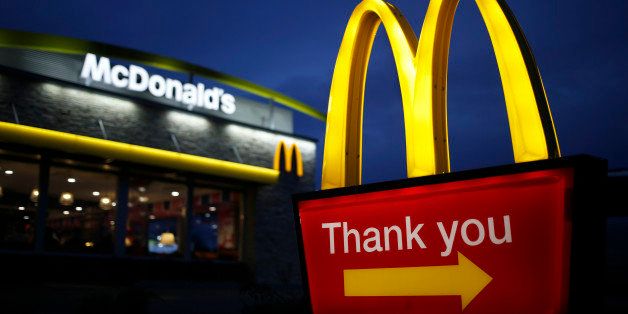 Golden arches mark the entrance to a McDonald's Corp. restaurant in Shelbyville, Kentucky, U.S., at dawn on Friday, Jan. 23, 2015. McDonald's Corp., the world's largest restaurant chain, posted same-store sales that declined less than analysts expected as menu changes started to turn around results in the U.S. Photographer: Luke Sharrett/Bloomberg via Getty Images
