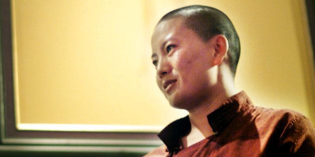 Nepalese Buddhist nun Ani Choying Drolma performs for Singaporeans at a trendy night spot Tuesday, Oct. 2, 2001, in Singapore. Drolma who says she gets called the "disco nun" after a DJ remixed one of her Nepalese chants into a trip-hop song. (AP Photo/Ed Wray)