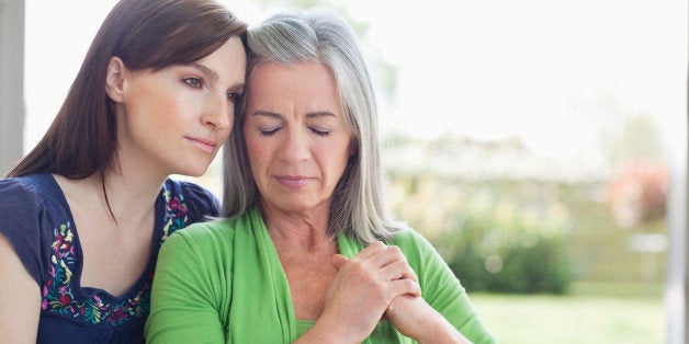 Woman consoling sad mother