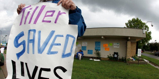 Corey Swertfager, of Wichita, Kan. and other pro-choice activists stand outside George Tiller's abortion clinic to counter a planned appearance by the Operation Rescue anti-abortion group Saturday, June 20, 2009, in Wichita, Kan. Tiller was killed May 31 while attending church services. (AP Photo/Charlie Riedel)