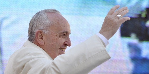 Pope Francis waves to the crowd as he arrives in St Peter's square for the 60th anniversary of the Comunione e Liberazione (Communion and Liberation) catholic mouvement on March 7, 2015 at the Vatican. AFP PHOTO / ANDREAS SOLARO (Photo credit should read ANDREAS SOLARO/AFP/Getty Images)