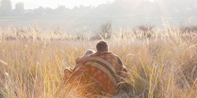 Couple relaxing in field