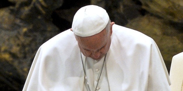 Pope Francis prays during his meeting with followers of the Neocatechumenal Way missionary movement, at the Aula Paolo VI at the Vatican on March 6, 2015. AFP PHOTO / ANDREAS SOLARO (Photo credit should read ANDREAS SOLARO/AFP/Getty Images)