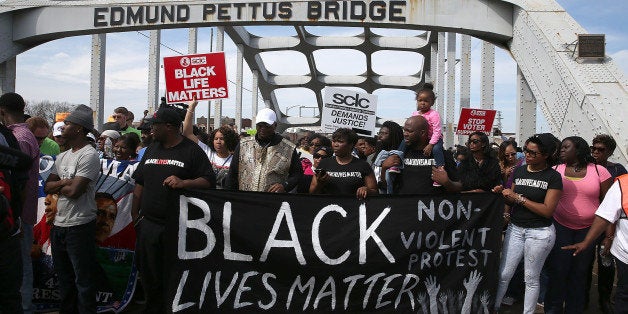SELMA, AL - MARCH 08: Thousands of people walk across the Edmund Pettus Bridge during the 50th anniversary commemoration of
