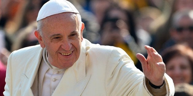 Pope Francis greets the crowds as arrives for his weekly general audience in St. Peter's Square on March 11, 2015 at the Vati
