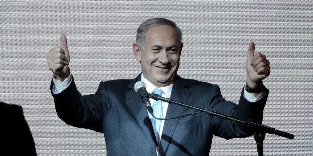 TEL AVIV, ISRAEL - MARCH 18: Israeli Prime Minister and the leader of the Likud Party Benjamin Netanyahu greets supporters at the party's election headquarters after the first results of the Israeli general election on March 18, 2015 in Tel Aviv, Israel. (Photo by Salih Zeki Fazlioglu/Anadolu Agency/Getty Images)