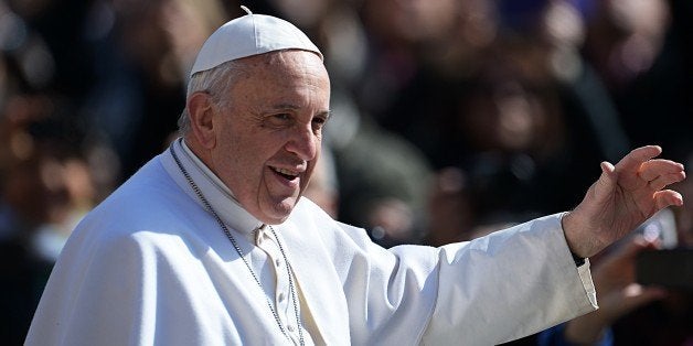 Pope Francis waves to faithful on March 18, 2015 upon his arrival on St. Peter's square at the Vatican to lead his weekly general audience. AFP PHOTO /VINCENZO PINTO (Photo credit should read VINCENZO PINTO/AFP/Getty Images)