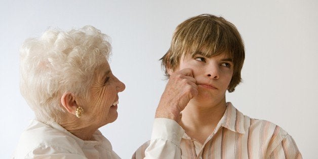 Woman grabbing grandson's cheek