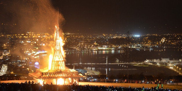 LONDONDERRY, NORTHERN IRELAND - MARCH 21: Thousands of people watch as the Temple by renowned Burning Man artist David Best is set ablaze on March 21, 2015 in Londonderry, Northern Ireland. Members of the public have used the Temple for the last seven days as a space for contemplation and remembrance, leaving mementos, messages and photographs in its interior. The Temple, made of an intricate timber frame was built by the cross communities of Derry, working with the Artichoke Trust project and partners, the Nerve Centre and the Waterside Neighbourhood Partnership with David Best describing the concept behind the temple for people to 'share in the celebration of peace in Northern Ireland'. (Photo by Charles McQuillan/Getty Images).