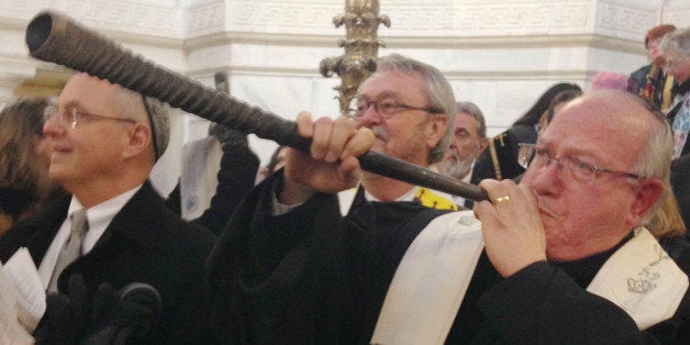 Rabbi Wayne Franklin of Temple Emanu-El in Providence, R.I., blows the Shofar, a Jewish tradition to call the community to assemble, as faith leaders met Wednesday, Jan. 7, 2015 at the Statehouse in Providence to call for legislation to fight poverty. The faith leaders gather annually on the first full working day of the General Assembly, and on her first full day in office, Gov. Gina Raimondo repeated to them a promise she made in her inaugural speech to work to create middle-class, family-supporting jobs. (AP Photo/Jennifer McDermott)