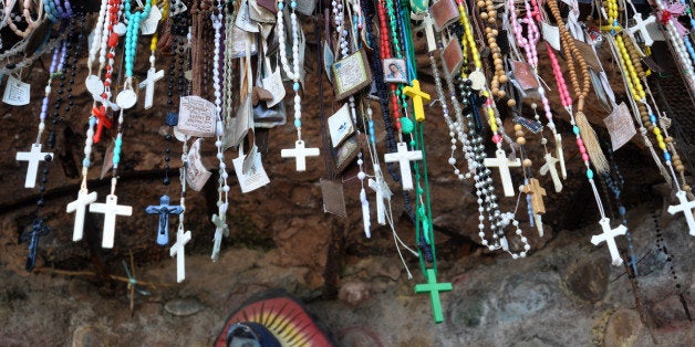 CHIMAYO, NM - NOVEMBER 10, 2012: Rosary beads, scapulars and other Christian sacramentals left by visitors to the Santuario de Chimayo, a Roman Catholic church in Chimayo, New Mexico, built by Spanish missionaries in 1816. The shrine, a National Historic Landmark, is famous as a contemporary pilgrimage site where many visitors take a small amount of 'holy dirt' in hopes of a miraculous cure for themselves or a loved one. (Photo by Robert Alexander/Archive Photos/Getty Images)5104602RA_Chimayo23.jpg