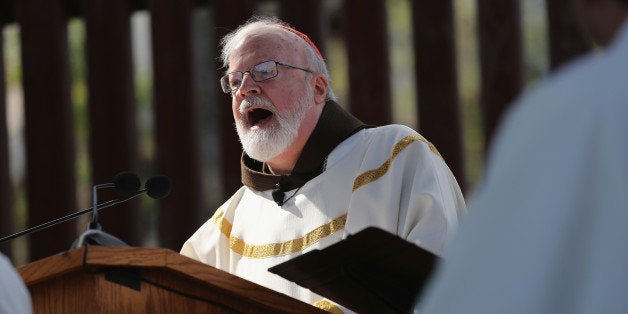 NOGALES, AZ - APRIL 01: Archbishop of Boston Cardinal Sean O'Malley speaks next to the U.S.-Mexico border fence during a special 'Mass on the Border' on April 1, 2014 in Nogales, Arizona. Catholic bishops led by Cardinal O'Malley held the mass to pray for comprehensive immigration reform and for those who have died along the border. (Photo by John Moore/Getty Images)