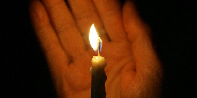 An Orthodox Christian worshipper holds a candle during the Easter Resurrection Service at the Patriarchal Cathedral of St. Ge