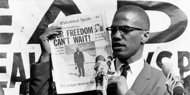 Black Muslim leader Malcolm X holds up a paper for the crowd to see during a Black Muslim rally in New York City on Aug. 6, 1963. (AP Photo)