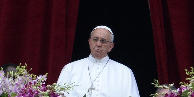 Pope Francis stands at the central loggia of St Peters' basilica during the 'Urbi et Orbi' blessing for Rome and the world following the Easter Mass on April 5, 2015 in Vatican. Pope Francis condemned, yesterday, indifference and 'complicit silence' to jihadist attacks on Christians as he presided over Easter ceremonies in the wake of a massacre of nearly 150 people at a Kenyan university by Shebab Islamists. The leader of the world's 1.2 billion Catholics brought up the extremist persecution of Christians as the holiest ceremonies of the Church calendar reached a climax today, when believers celebrate the resurrection of Jesus. AFP PHOTO / FILIPPO MONTEFORTE (Photo credit should read FILIPPO MONTEFORTE/AFP/Getty Images)