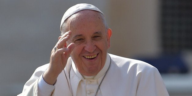 Pope Francis waves to faithful on April 15, 2014 upon his arrival on St. Peter's square at the Vatican to lead his weekly gen